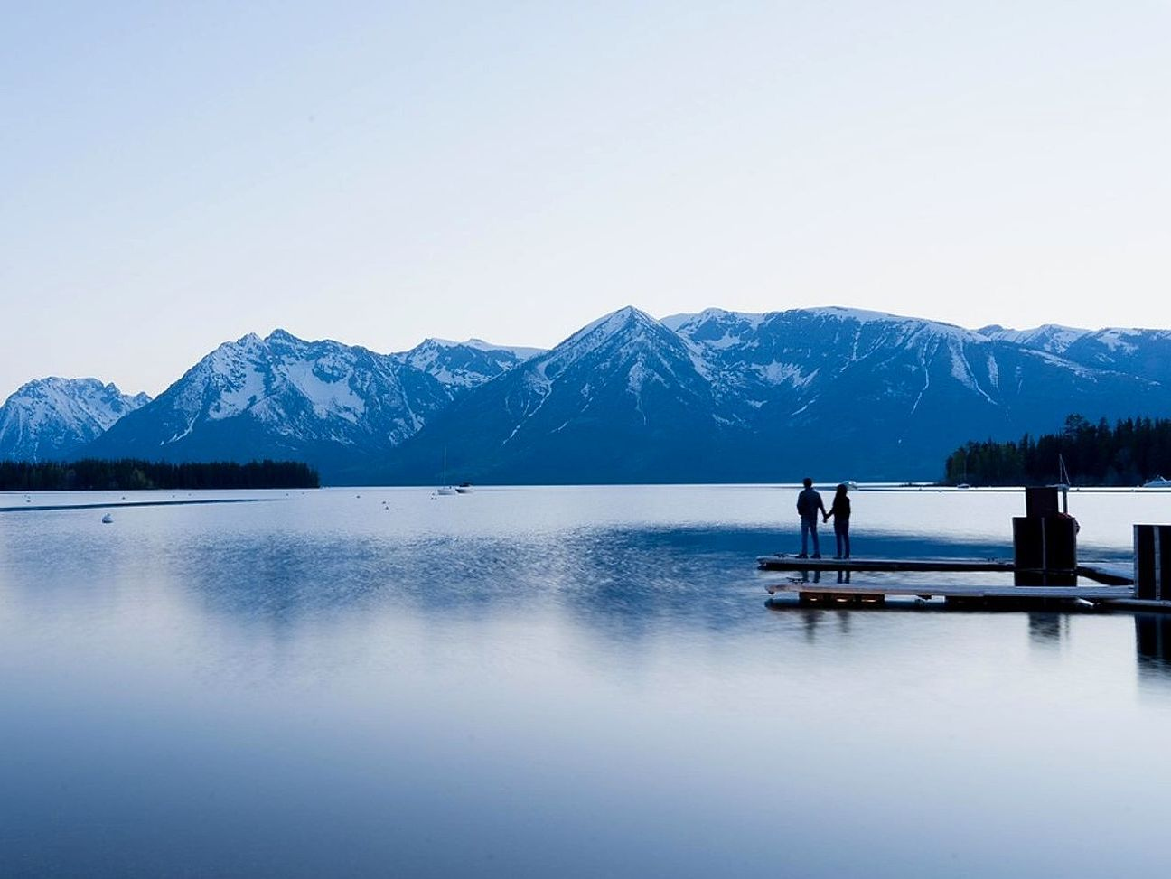 Lakeside wooden cabin photographed at sunrise
